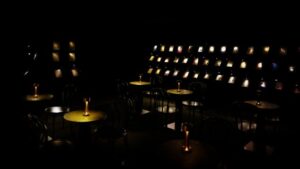 Small reading lamps are set up — just enough light for reading