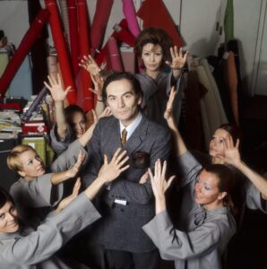 Pierre Cardin stands in his studio surrounded by models